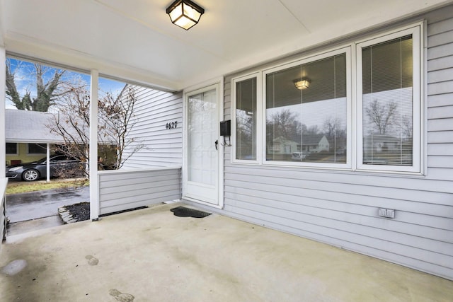 view of exterior entry featuring a patio area