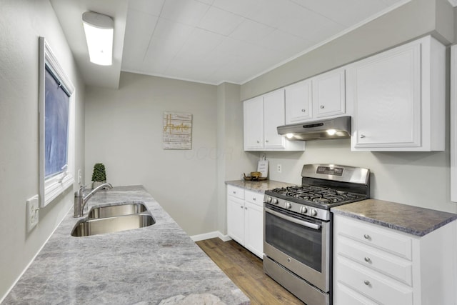 kitchen featuring white cabinetry, sink, hardwood / wood-style flooring, and stainless steel gas range oven