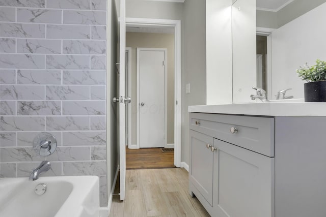 bathroom featuring shower / tub combination, wood-type flooring, and vanity