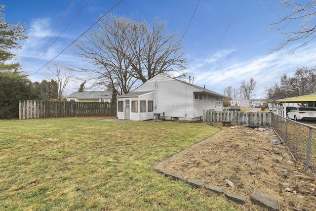 exterior space featuring a lawn and a sunroom