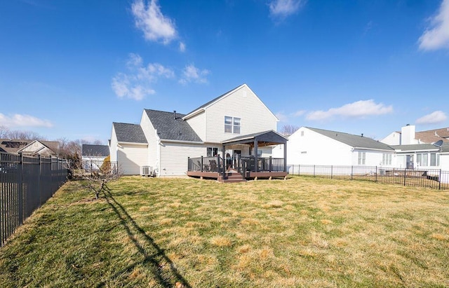 rear view of house with central AC unit, a yard, and a deck