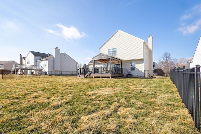 back of property featuring a gazebo, a deck, and a lawn