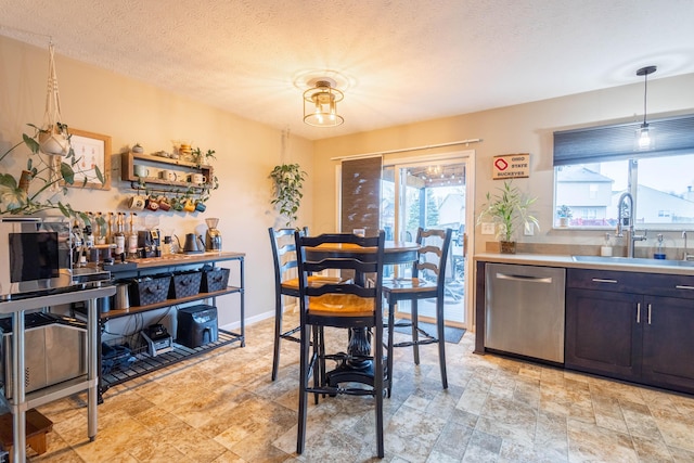 dining room with sink and a textured ceiling