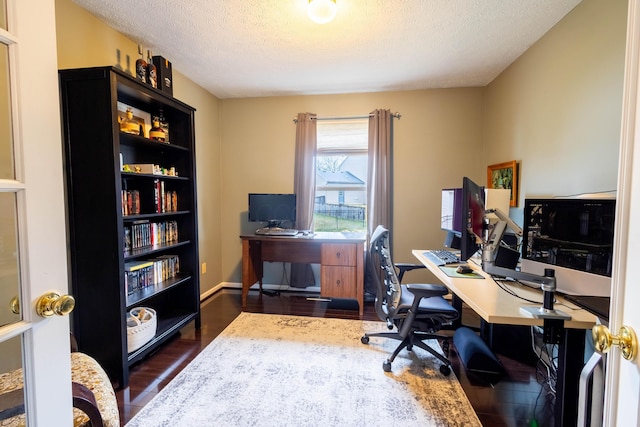 office featuring dark wood-type flooring and a textured ceiling