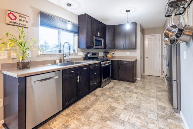 kitchen featuring pendant lighting, dark brown cabinetry, appliances with stainless steel finishes, and sink