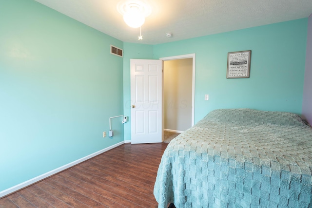 bedroom featuring dark hardwood / wood-style flooring