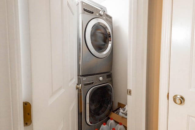 washroom featuring stacked washing maching and dryer