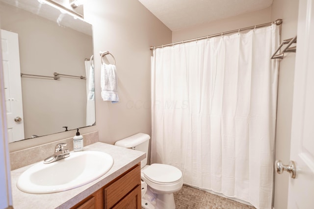 bathroom with vanity, a textured ceiling, and toilet