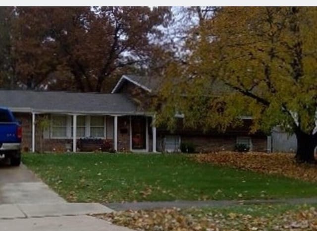 view of front of home with a front lawn and a porch