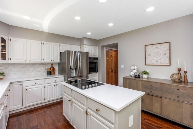 kitchen featuring black appliances, light countertops, white cabinetry, dark wood-type flooring, and a kitchen island