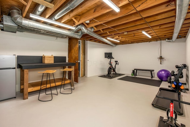 exercise area featuring concrete block wall