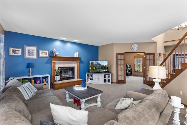 carpeted living room with a fireplace and french doors