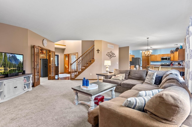 living room featuring light carpet and a chandelier