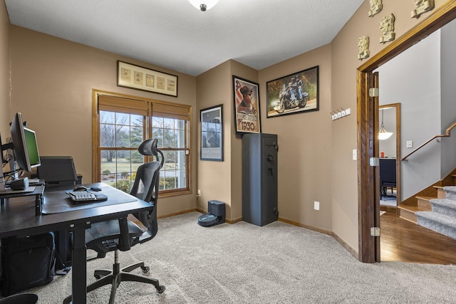 carpeted home office with a textured ceiling