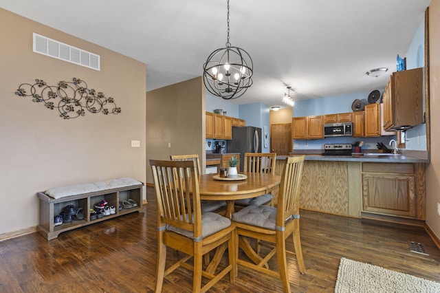 dining room with sink and dark wood-type flooring