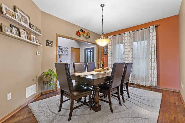 dining area with dark wood-type flooring