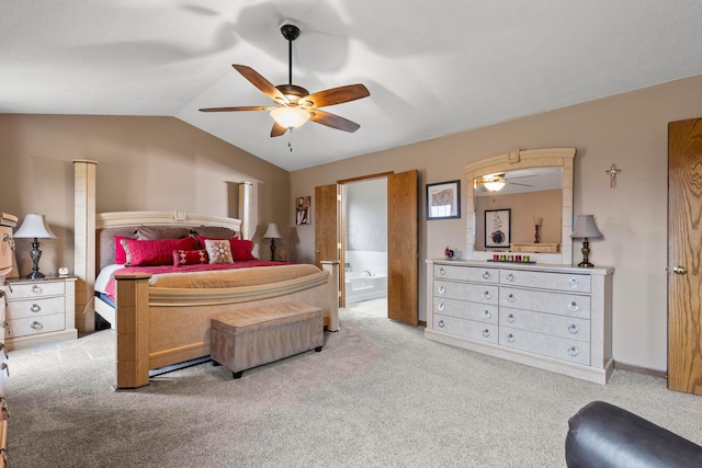 carpeted bedroom with ceiling fan, vaulted ceiling, and connected bathroom