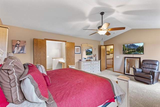 bedroom featuring carpet floors, vaulted ceiling, connected bathroom, and ceiling fan