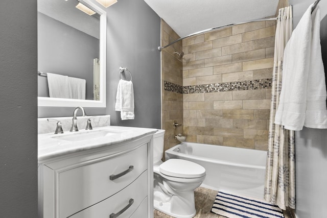 full bathroom with toilet, a textured ceiling, vanity, and shower / tub combo