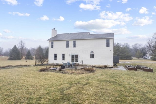 back of house with a yard and a patio area