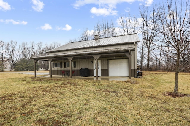 exterior space featuring a garage and a yard