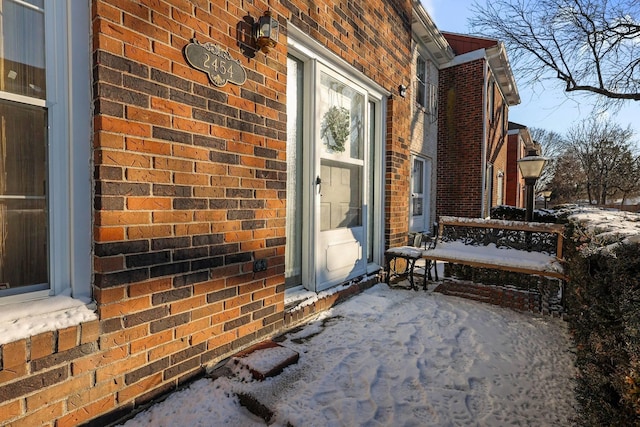 view of snow covered property entrance