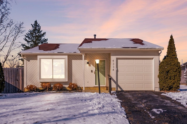 ranch-style house featuring a garage