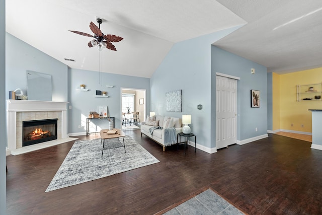 living area with dark wood-style flooring, a fireplace, visible vents, ceiling fan, and baseboards