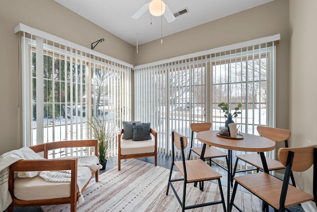 sunroom featuring ceiling fan and visible vents