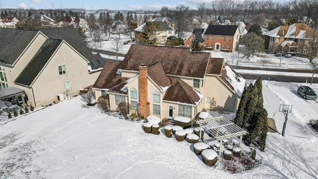 snowy aerial view featuring a residential view