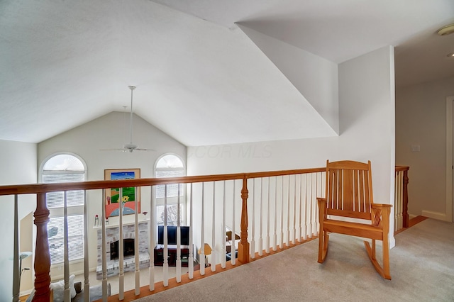 hallway with lofted ceiling and carpet floors