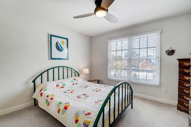 bedroom with a ceiling fan, light colored carpet, and baseboards