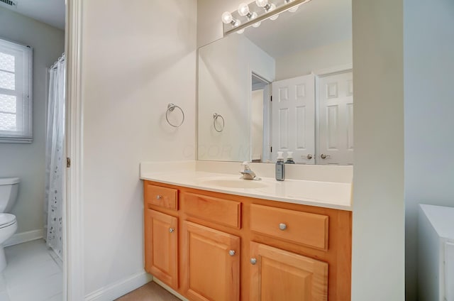 bathroom featuring visible vents, baseboards, toilet, and vanity