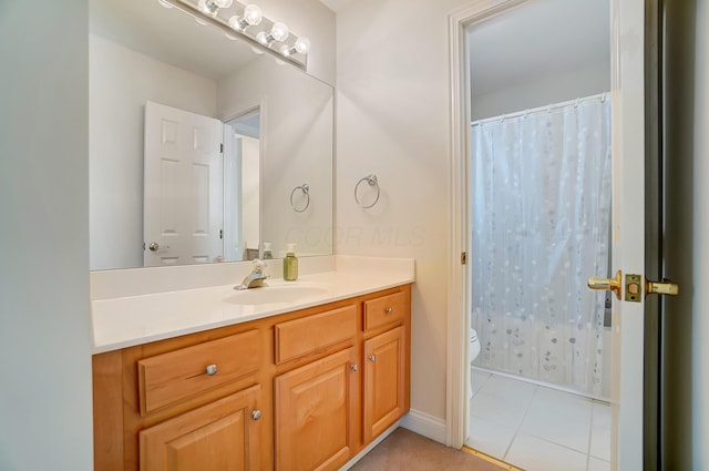 bathroom featuring a shower with curtain, toilet, vanity, and tile patterned flooring