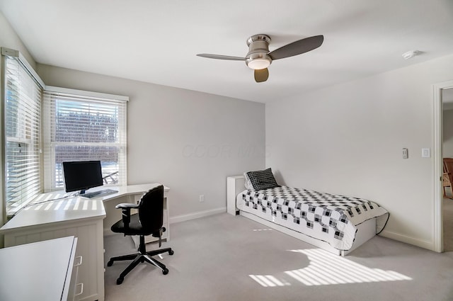 bedroom featuring light carpet, a ceiling fan, and baseboards