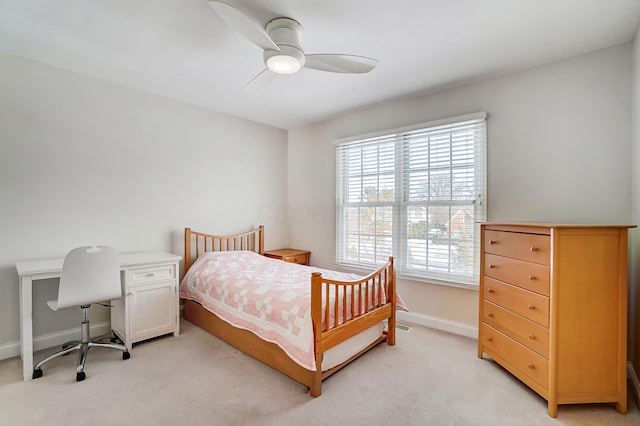 bedroom featuring a ceiling fan, light colored carpet, and baseboards