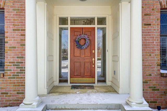 doorway to property featuring brick siding