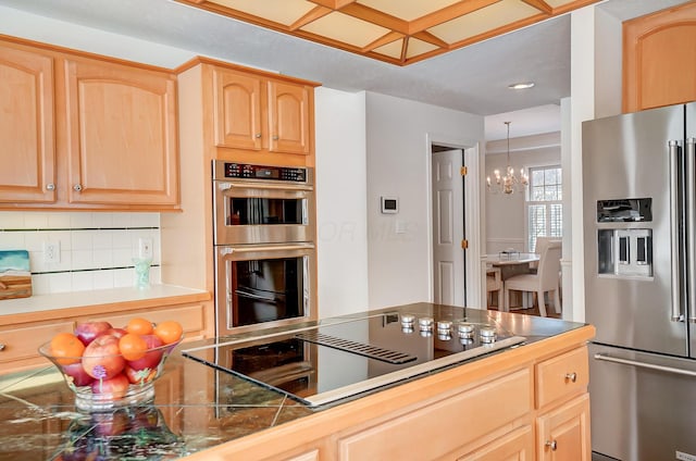 kitchen with light brown cabinetry, appliances with stainless steel finishes, and tasteful backsplash