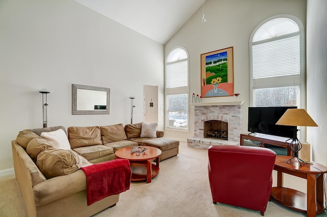 carpeted living room with a fireplace and high vaulted ceiling