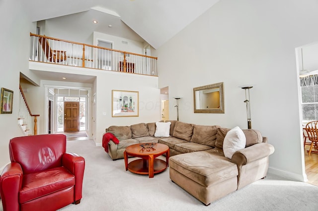 carpeted living room featuring stairway, baseboards, and high vaulted ceiling