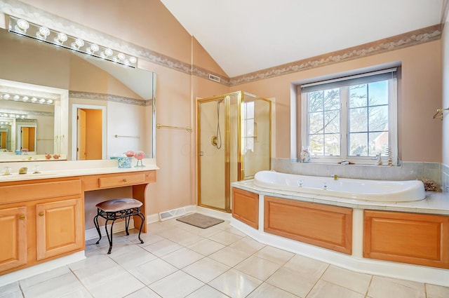 full bathroom with vanity, vaulted ceiling, a shower stall, tile patterned floors, and a bath