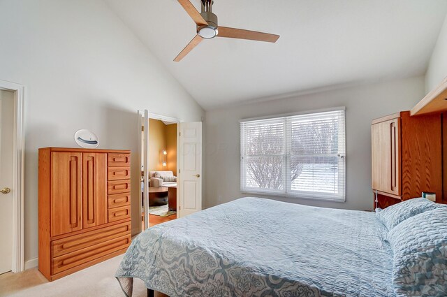 bedroom featuring light carpet, a ceiling fan, and vaulted ceiling