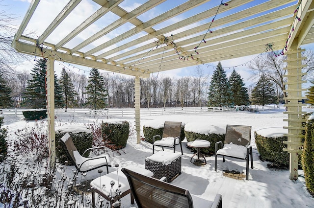 snow covered patio featuring fence and a pergola