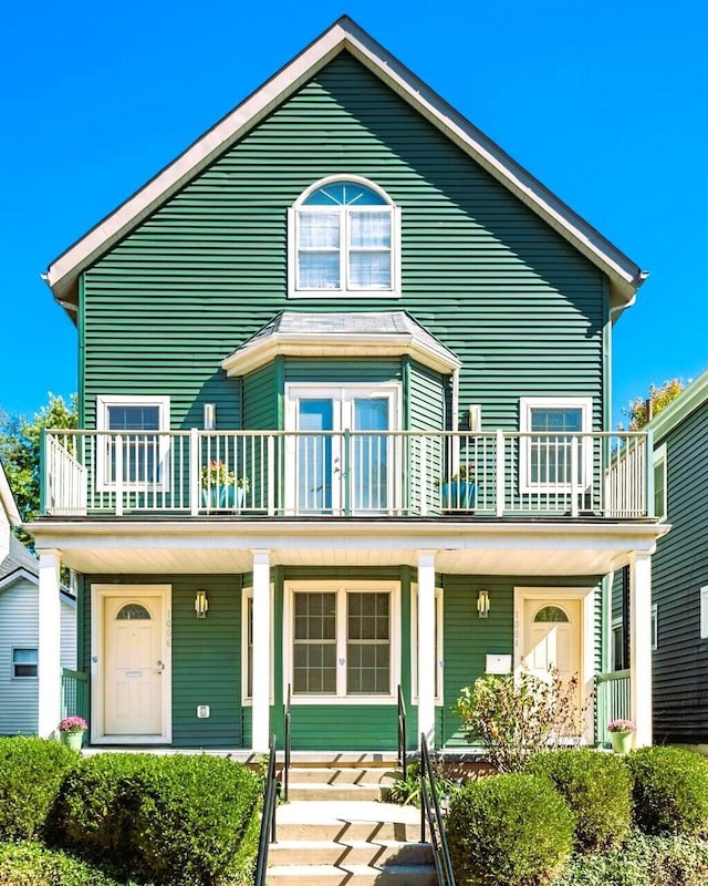 view of front of house with a porch and a balcony