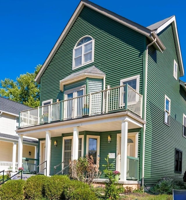 view of front of property featuring covered porch and a balcony