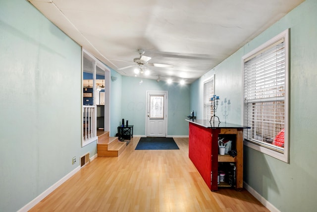 entryway with ceiling fan and hardwood / wood-style floors