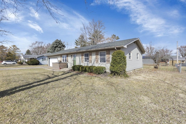 single story home featuring a garage and a front lawn