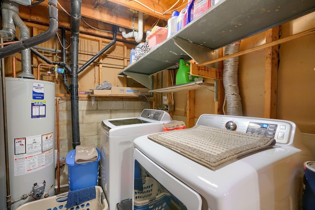 laundry room featuring washing machine and dryer, laundry area, and water heater