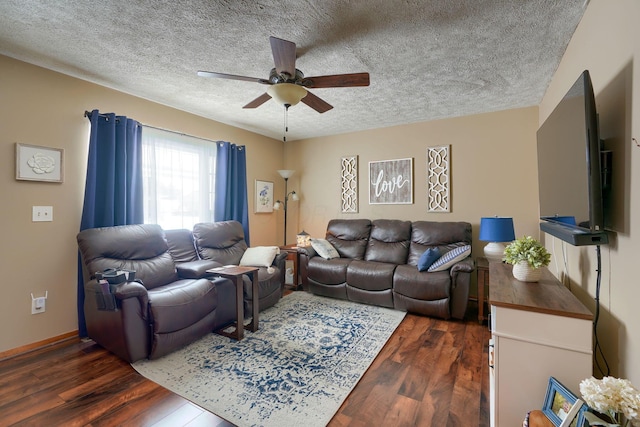 living area with baseboards, dark wood-type flooring, a textured ceiling, and ceiling fan