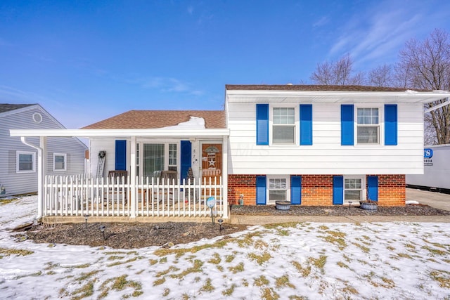 tri-level home featuring brick siding